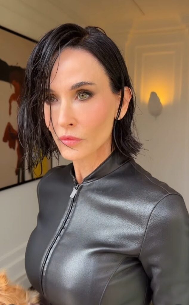 Demi Moore posed up a storm with her pet dog as she attended the Gucci show during Milan Fashion Week on Friday