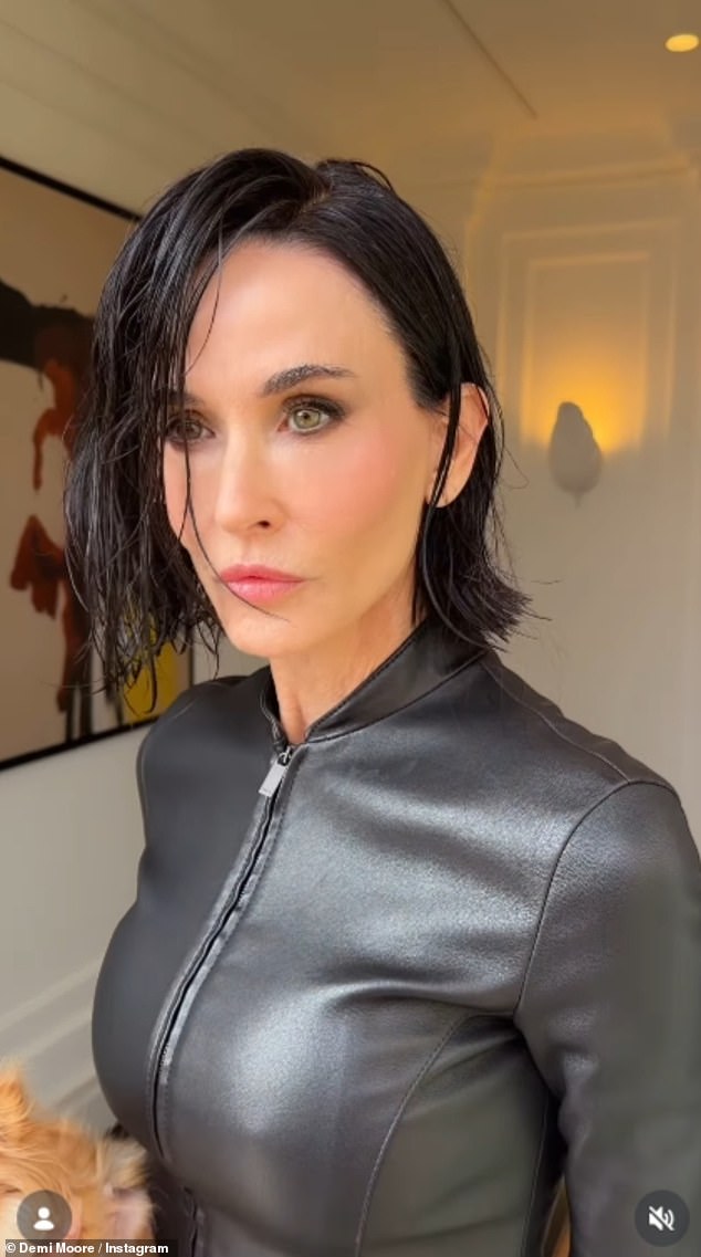 Demi Moore posed up a storm with her pet dog as she attended the Gucci show during Milan Fashion Week on Friday