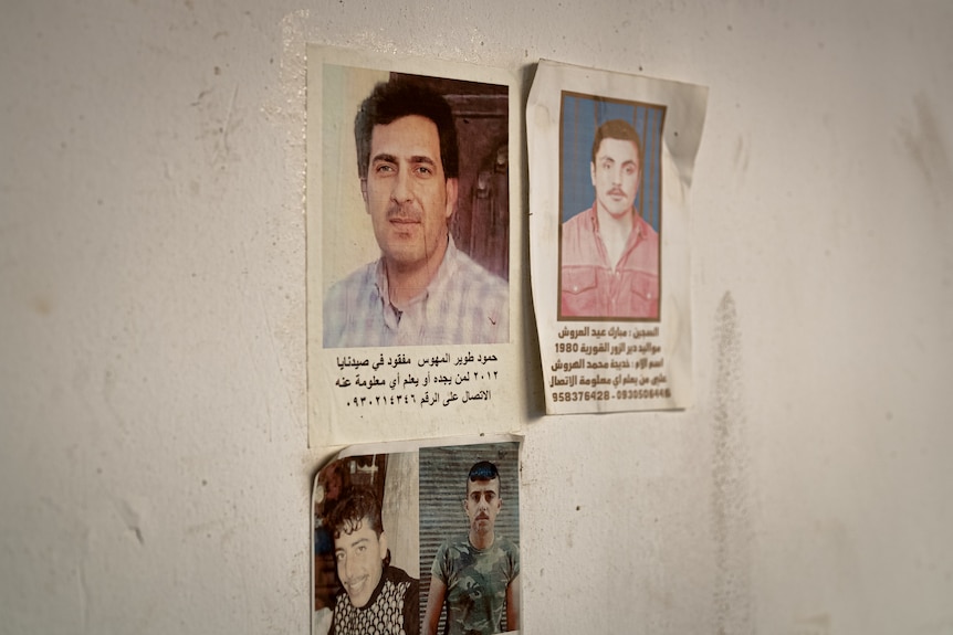 Posters of missing people on a wall.