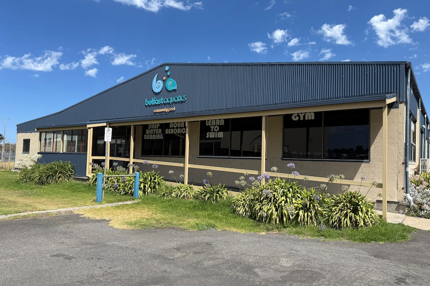 The exterior of a building that houses a pool.