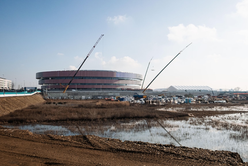Cranes outside the Milan Santagiulia ice hockey stadium