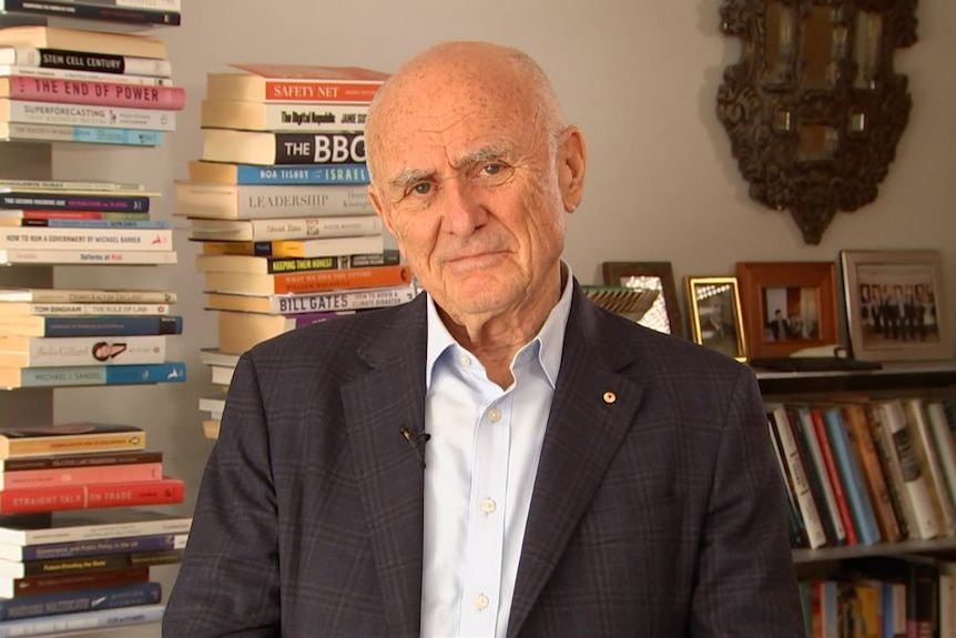 Former ACCC chair Allan Fels is a middle-aged man ina suit, looking at the camera