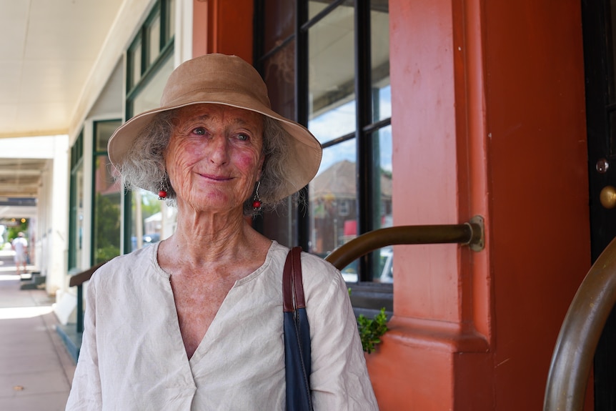 A lady standing on the main street.