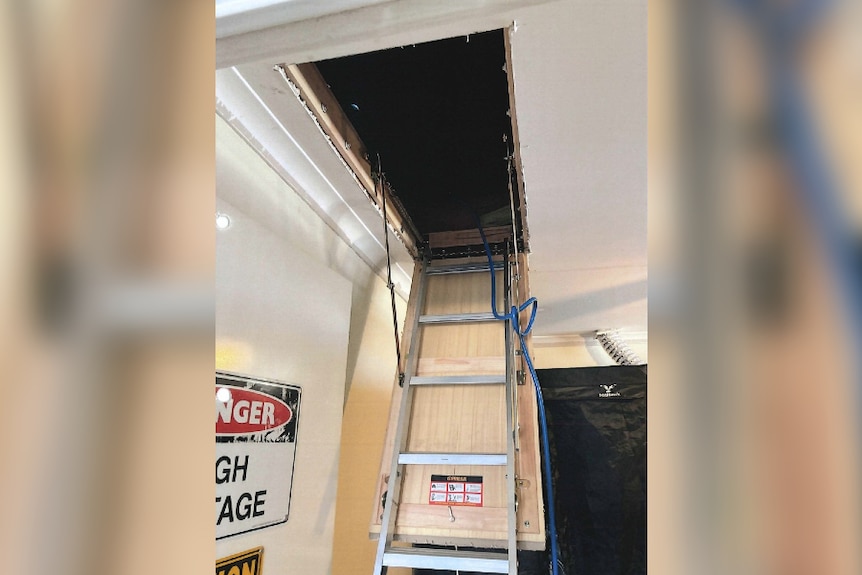 An image of loft modification shows the stairs to an house's attic