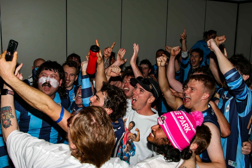 A group of AFL players celebrating