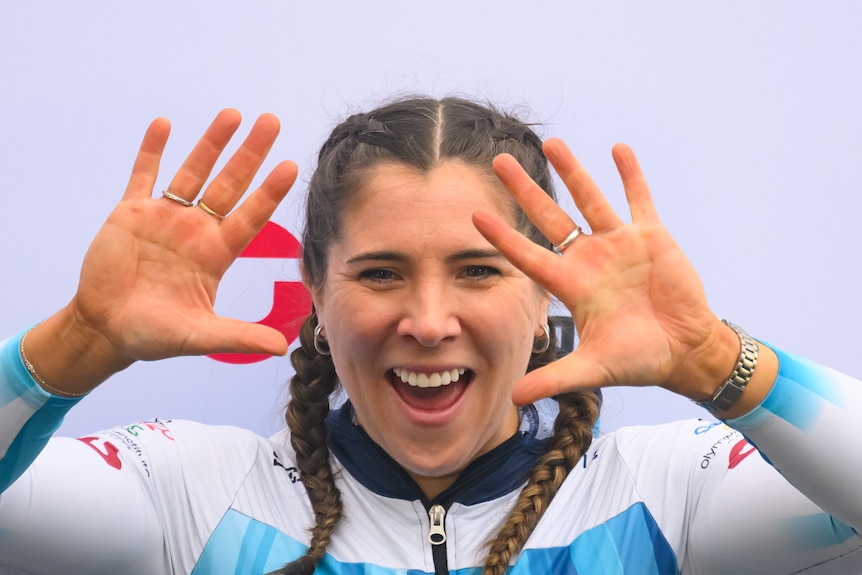Bree Walker smiles and holds her hands up in celebration of second place in the overall monobob standings