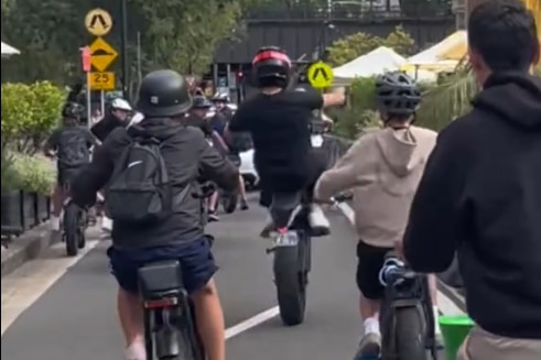 a group of e-bike riders through the sydney cbd