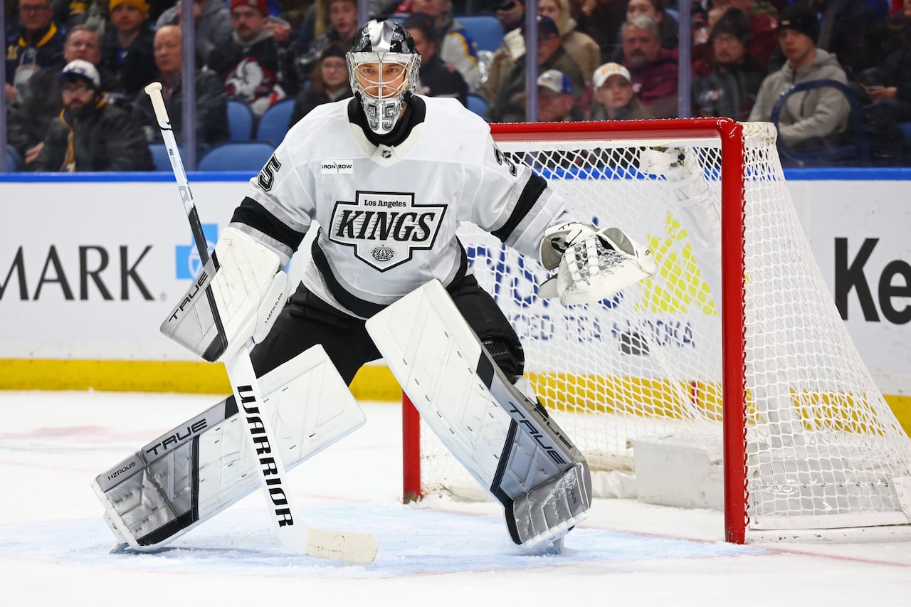 A hockey goaltender prepares to make a save.