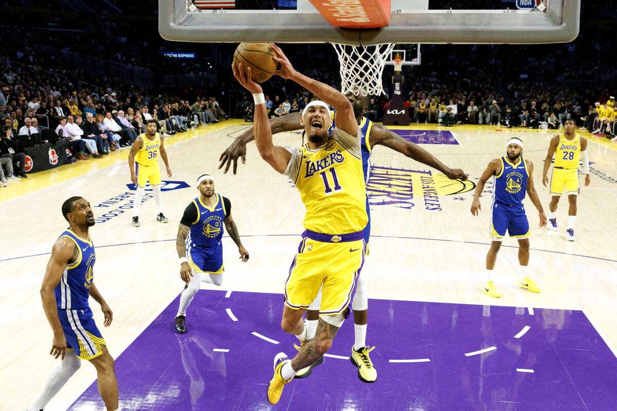 Lakers center Jaxson Hayes (11) scores in front of Warriors forward Draymond Green at Crypto.com Arena on Saturday.