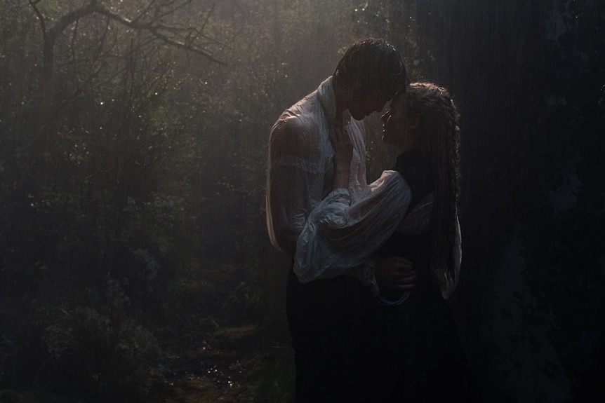a man and a woman passionately embrace in the rain