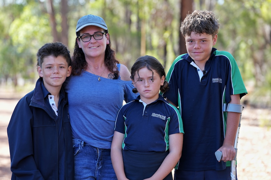 Woman with three children standing in bushland