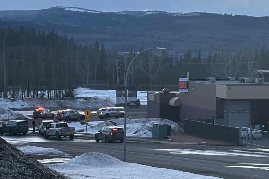 Canadian police vehicles outside a high school.