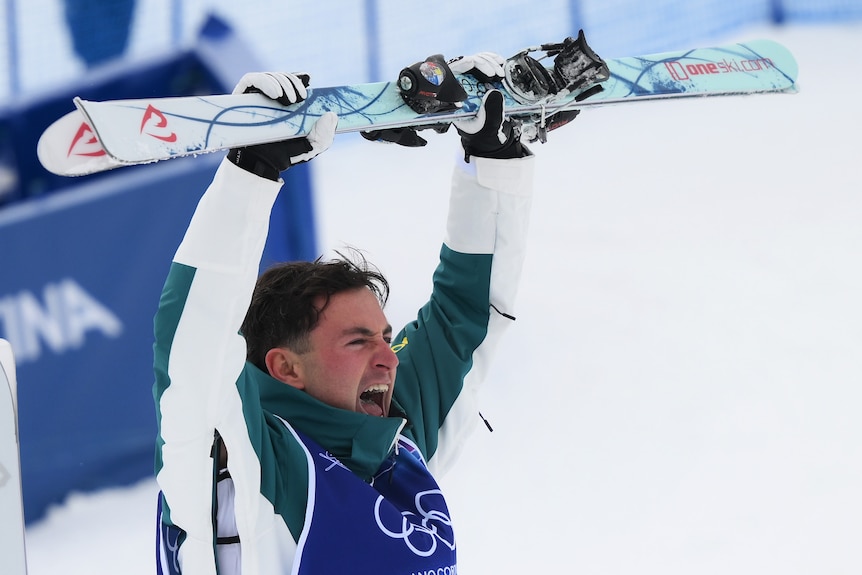 Cooper Woods holds up his skis