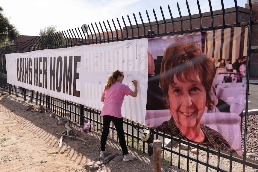 A woman signing a sign