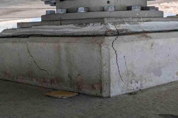 Cracking of concrete on a bridge structure.