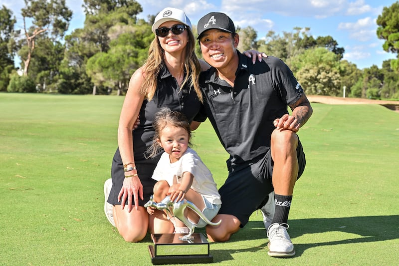 Anthony Kim celebrates with his wife Emily and his daughter Isabella. Photograph: Brenton Edwards/AFP via Getty Images