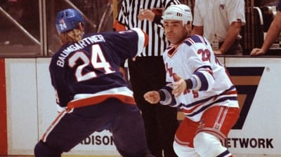 New York Islanders Ken Baumgartner squares off with the Rangers' Tie...