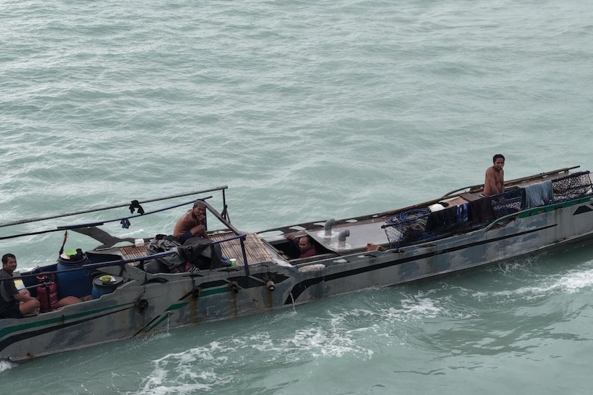 A drone image of a boat with several men on board