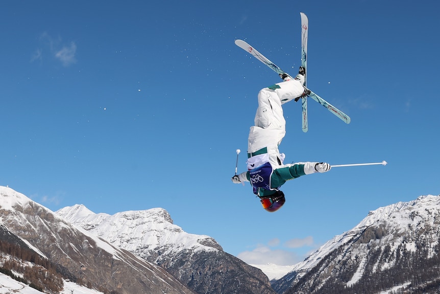 Matt Graham flips with mountains in the background