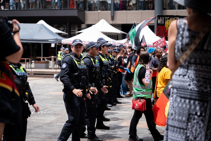 A crowd of people gather in central Perth to protest against Invasion Day.