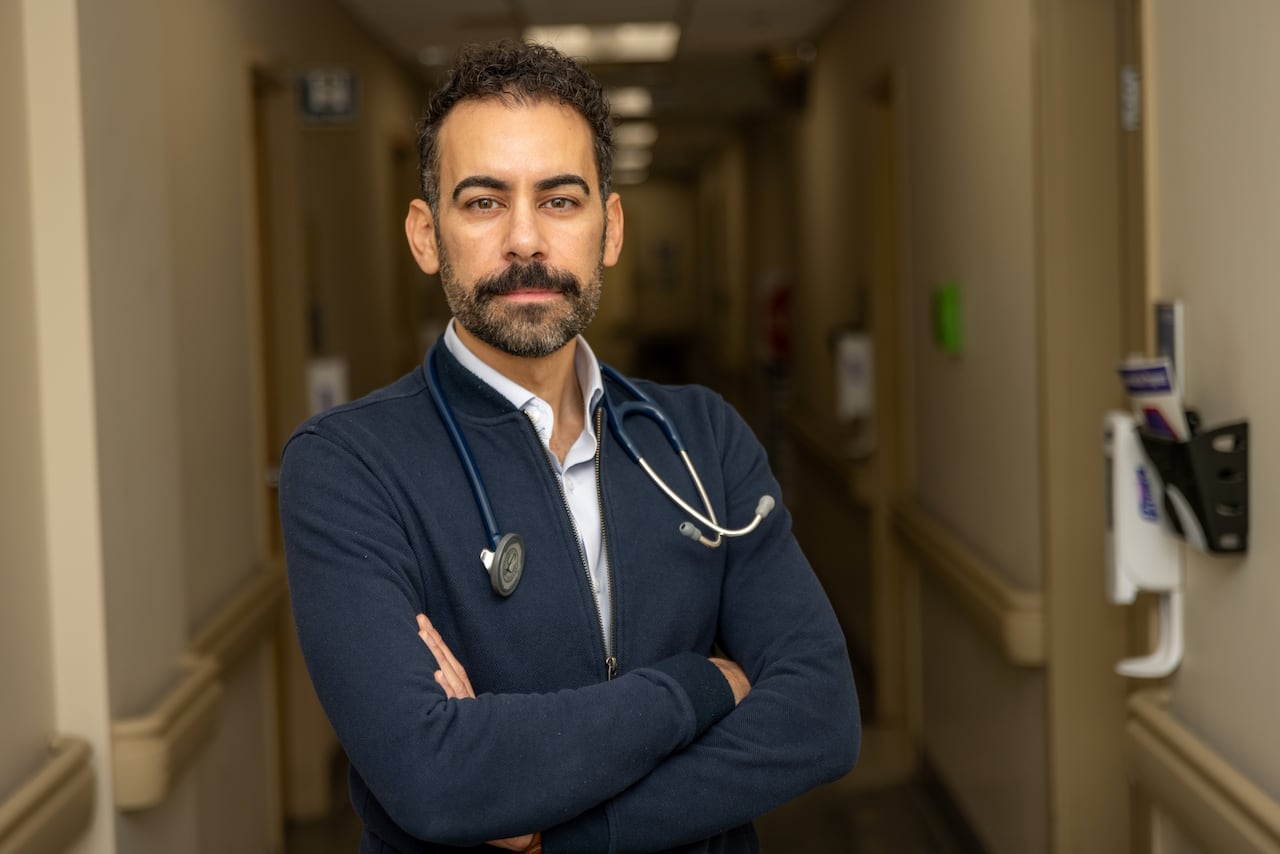 A doctor crosses his arms