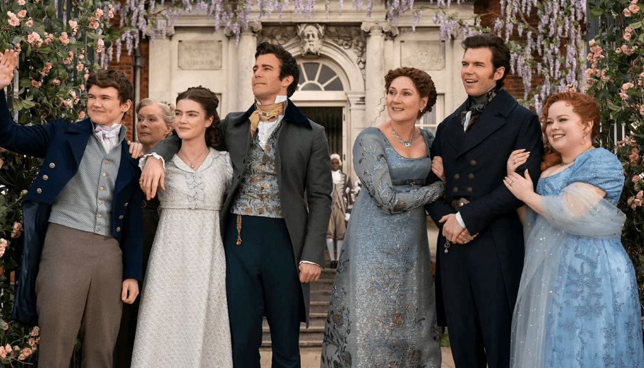 a group of people standing outside and looking in one direction 