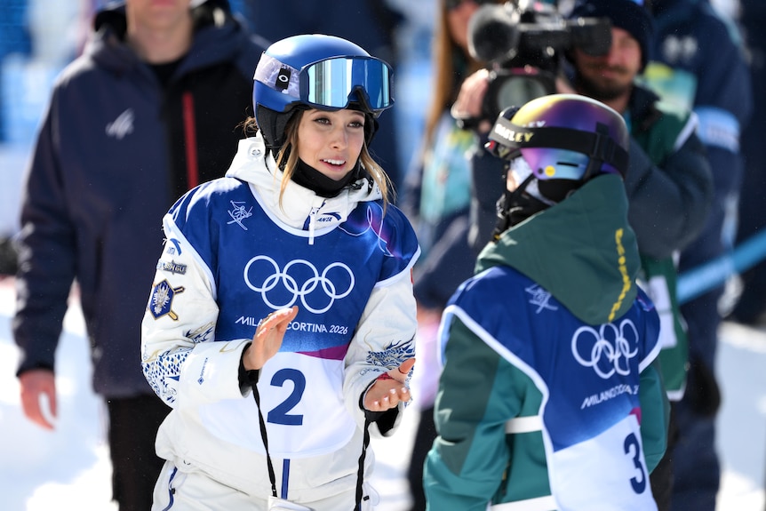 Eileen Gu talks to Indra Brown at the end of her run in the women's freeski halfpipe final at the Milano Cortina Winter Olympics