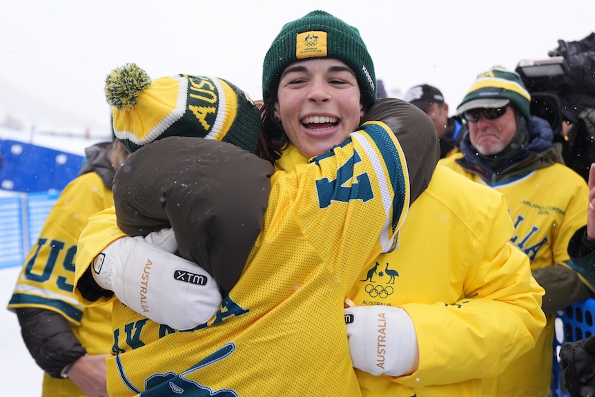 Jakara Anthony gets a hug from one of her fans at the Winter Olympics.