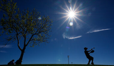 Logan Eaton, age 9, plays catch in the outfield before a spring training baseball game between the Texas Rangers and the Colorado Rockies, Sunday, Feb. 22, 2026, in Surprise, Ariz. (AP Photo/Charlie Riedel)