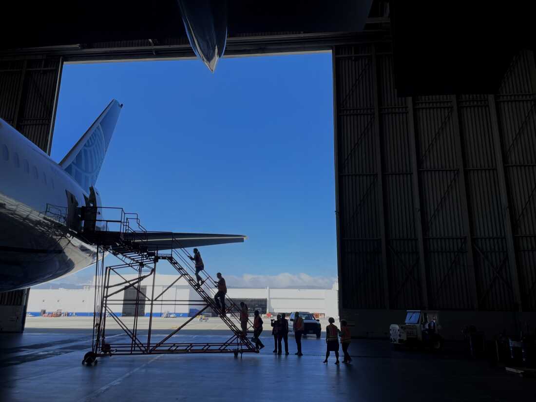 Participants in the Fear of Flying Clinic walk up the boarding stairs and into a 787 as part of a four-day course to help ease their anxiety around air travel. Getting exposed to the sights and sounds of airplane is one piece of that training.