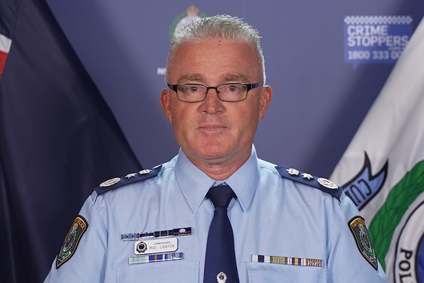NSW Police Commissioner Mal Lanyon stands behind a lecturn addressing the media