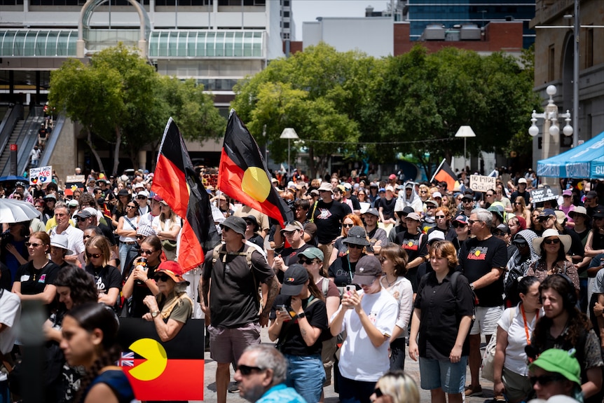 A crowd of people gather in central Perth to protest against Invasion Day.