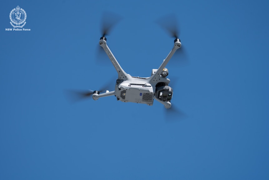 A drone in a blue sky.