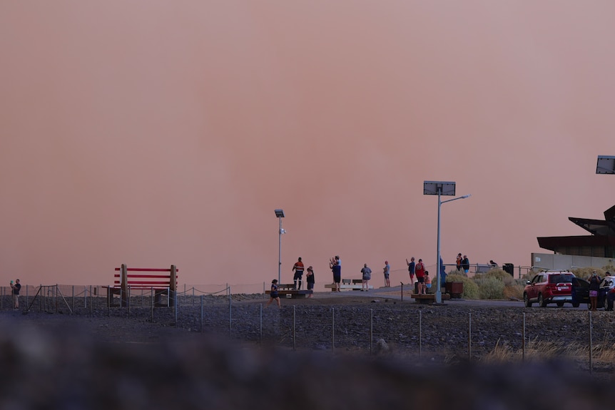 People taking photos of a dust storm rolling into Broken Hill.