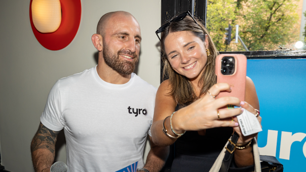 Alexander Volkanovski takes a photo with a fan at The Prince Alfred Hotel in Victoria. 