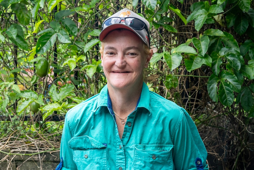 A woman smiles a the camera.