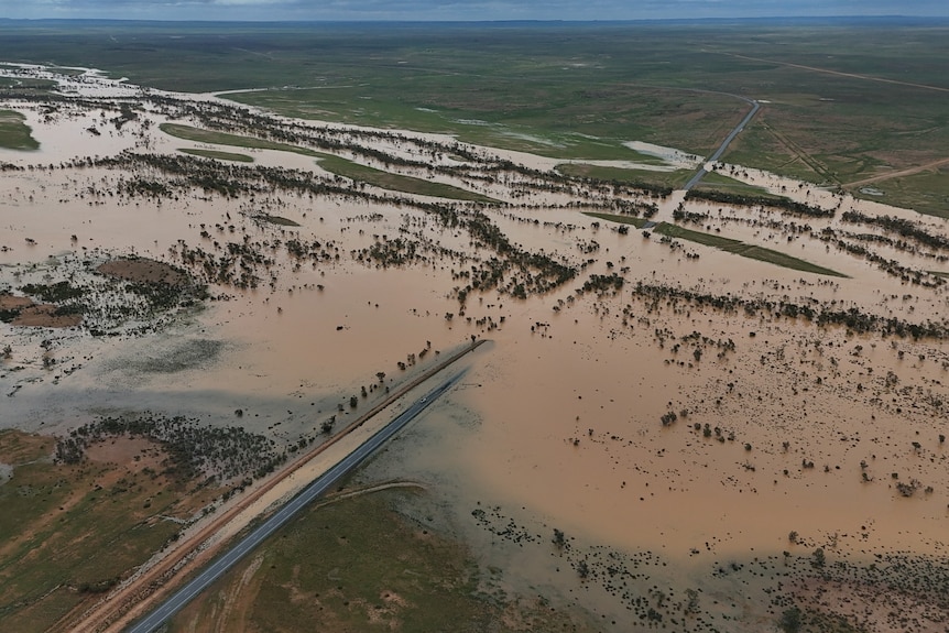 Overhead flooding outdoors with road and pastures