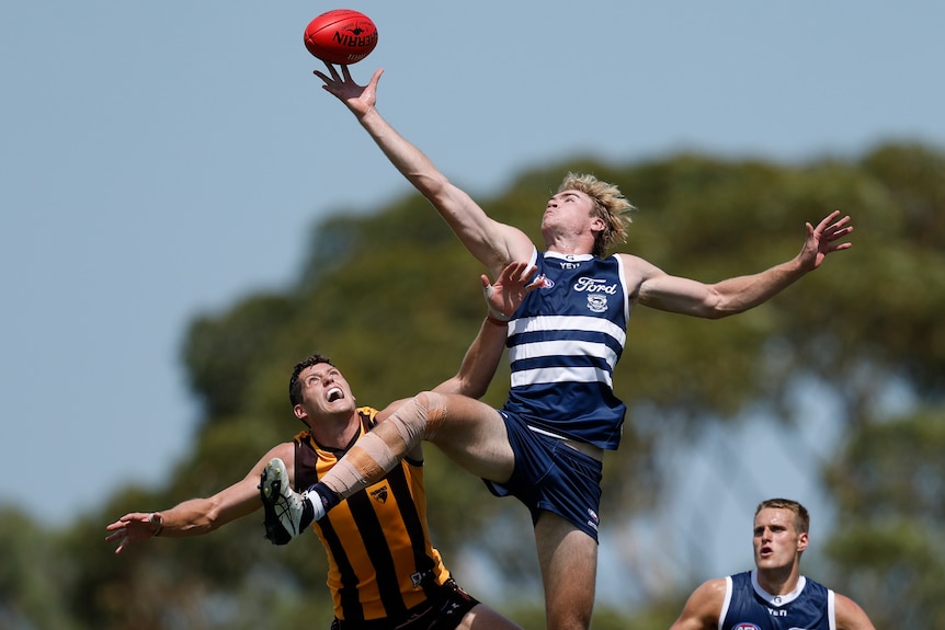 Mitch Edwards leaps above Lloyd Meek to tap the ball in a ruck contest