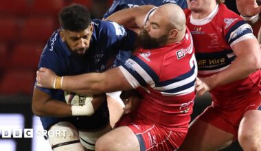 Doncaster's Joe Jones crouches and grabs another player in a tackle