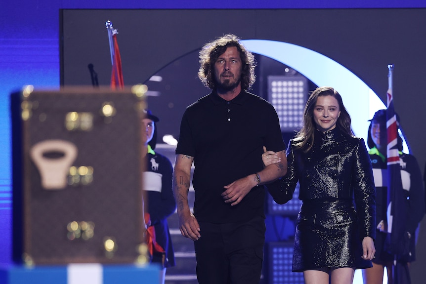 Marat Safin and Chloe Grace Moretz walk towards the trophy before the Australian Open men's singles final.