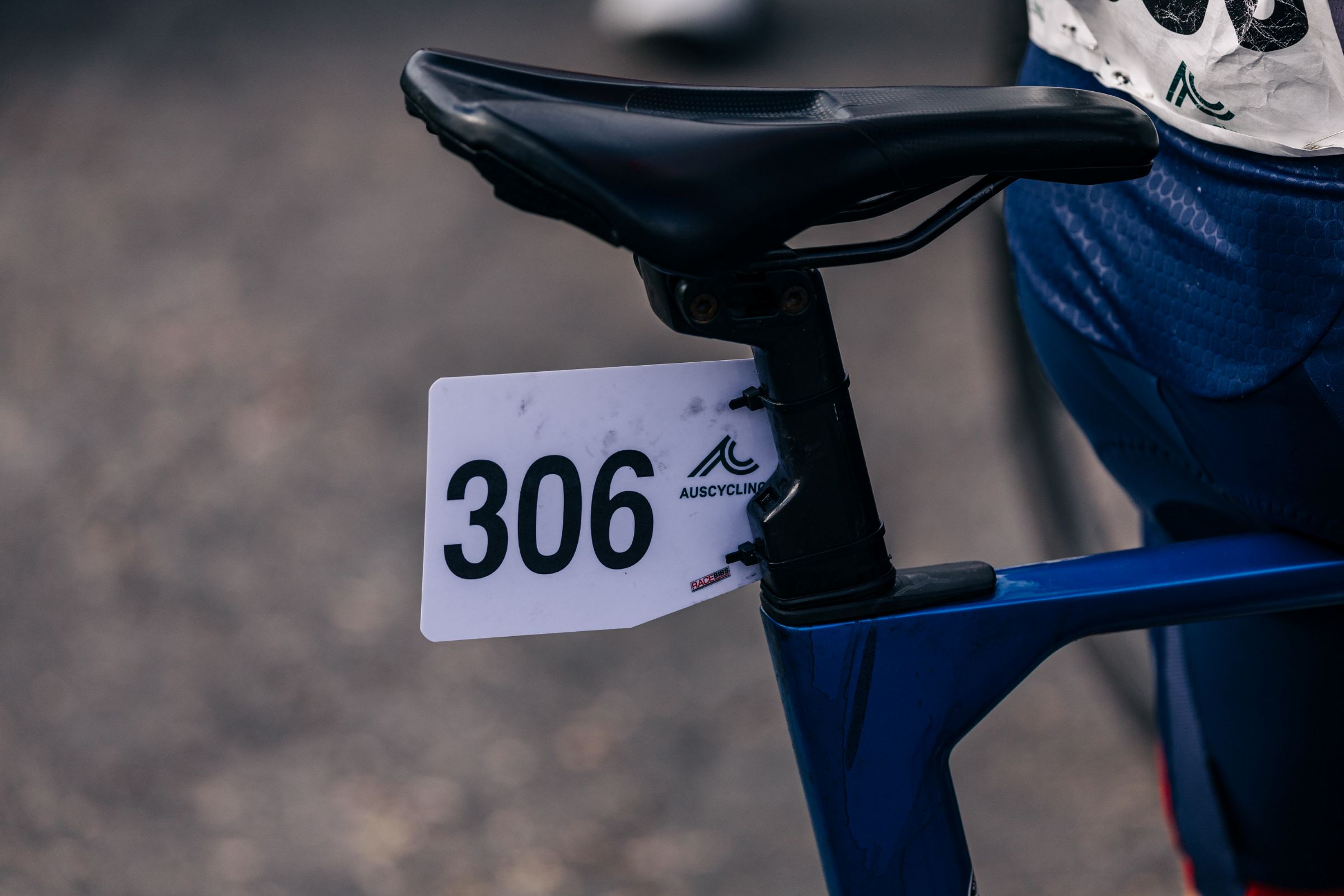 A race number '306' from an AusCycling road cycling race mounted on a bicycle seatpost