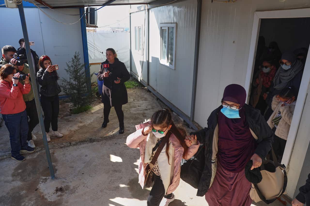 A group of Muslim women and children leaving a camp