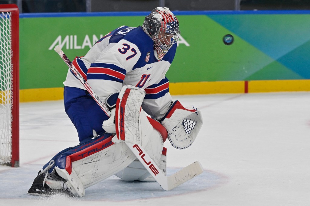 Connor Hellebuyck saves the puck during the men's play-off semi-final ice hockey match between USA and Slovakia at the Milano Santagiulia Ice Hockey Arena during the Milano Cortina 2026 Winter Olympic Games in Milan, on February 20, 2026. 