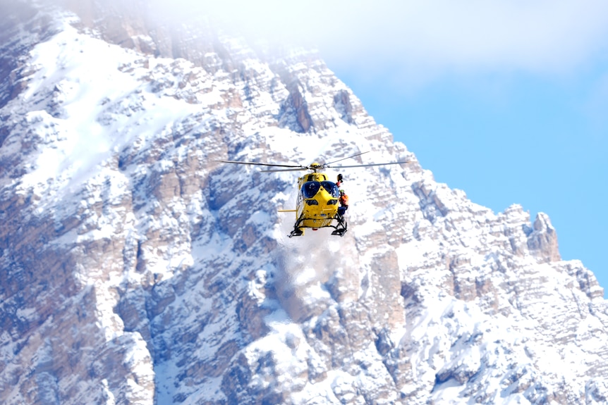 A helicopter with a mountain in the background