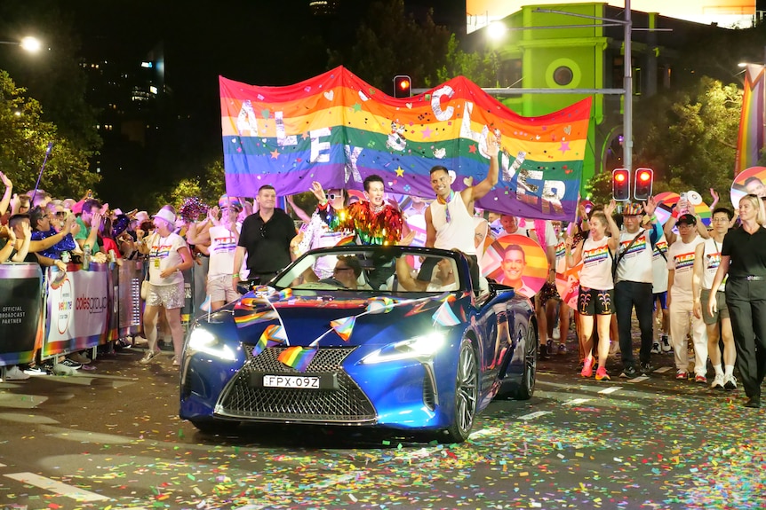 Clover Moore on the back of a blue convertible.