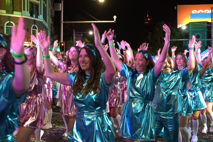 A group of people wearing blue outfits.