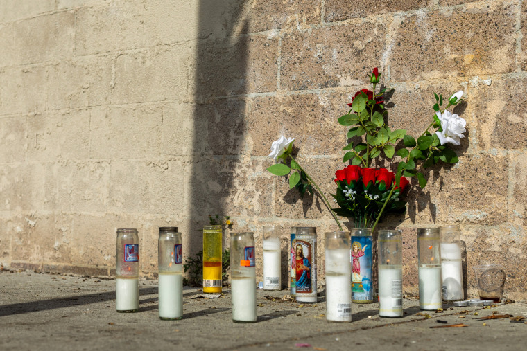 A memorial for former NFL and Westchester High lineman Kevin Johnson sit near a homeless encampment in L.A. 