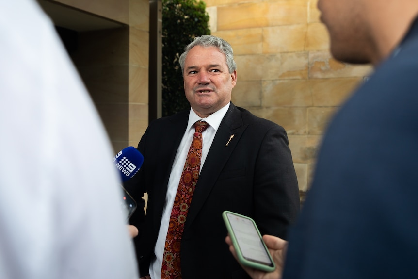 Stephen Price is interviewed by reporters.