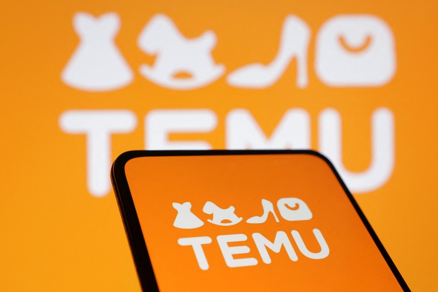 Orange logo of brand Temu displayed on a phone 