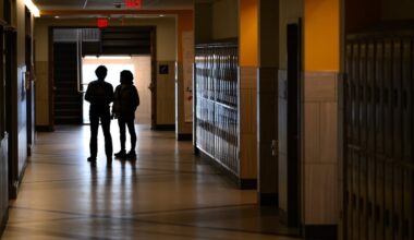 People talk after the school day in a hallway at Somerville High School, on Jan. 21.